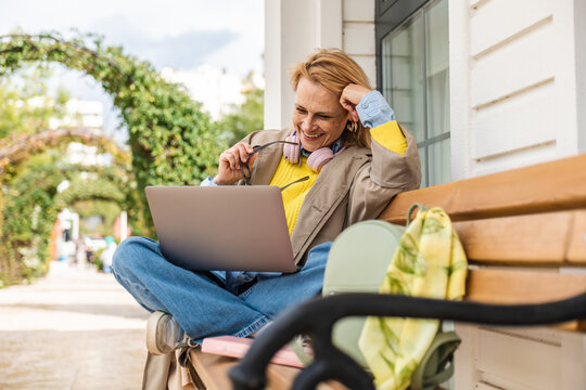 Woman enjoying leisure time with laptop outdoors