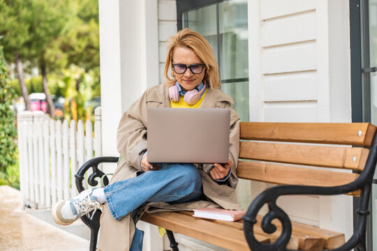 Woman enjoying technology in a serene outdoor setting