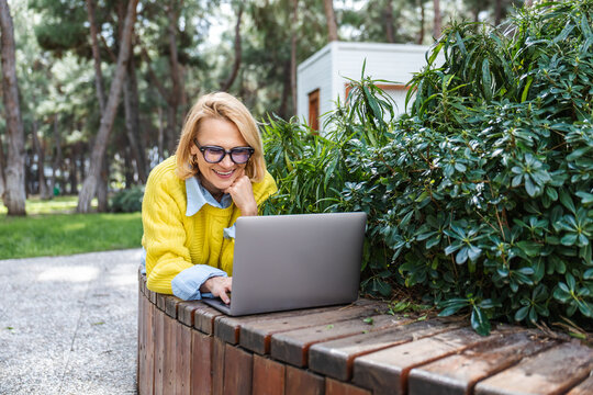 Woman enjoying remote work in a park setting