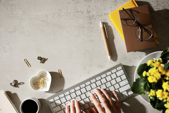 Feminine workspace with keyboard and flowers