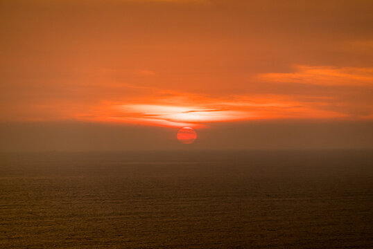 Tranquil sunset over calm ocean at golden hour