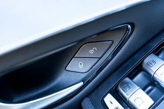 Close-up of car door panel with lock and window switch