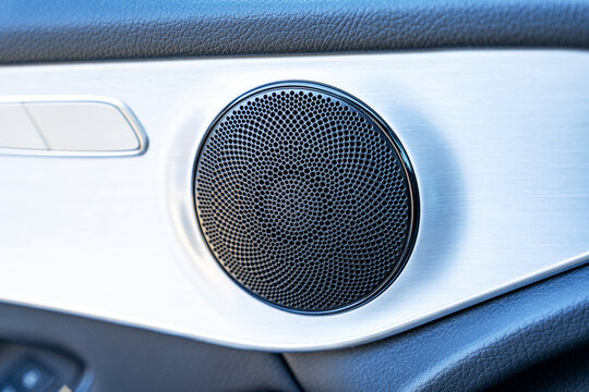 Close-up of premium car door speaker with metal trim