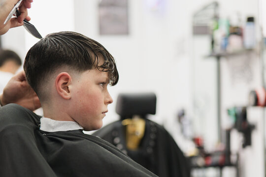 Boy getting a fresh haircut at a modern barbershop