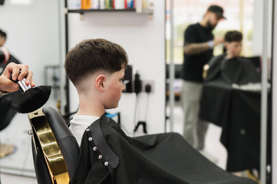 Boy getting a fresh fade haircut at a modern barbershop