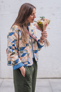 Mature woman enjoying urban lifestyle with flowers
