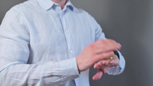 A close-up of an unrecognizable person flipping a coin. He loses and becomes aggressive towards the coin