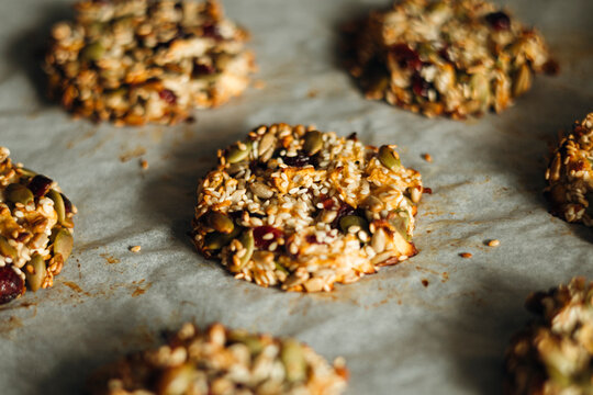 Homemade sugar-free seed cookies on parchment, diet snack