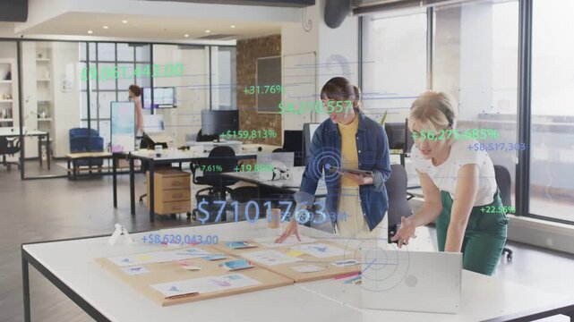 Vertical video: Tapping tablet, woman in blue leading review at office table with laptop overlays