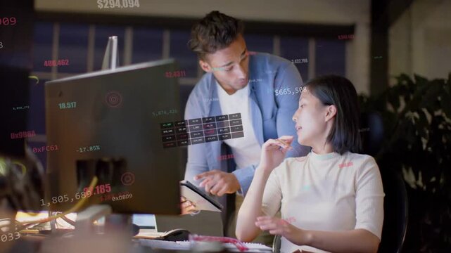 Seated woman gesturing at hologram data, causing man leaning with tablet, analyzing tech charts