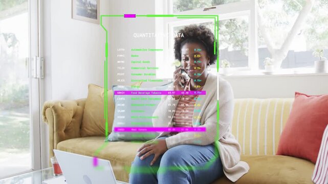 Woman lifting phone to ear and speaking while checking laptop, HUD updating business data on torso