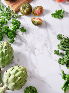 Fresh vegetables on marble countertop for healthy meal prep