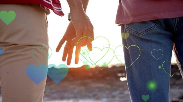Couple walking shore at sunset hearts rising spurring hands reaching locking romance marketing