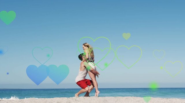 Woman walking to man reaching climbing man lifting and holding marketing on beach hearts floating