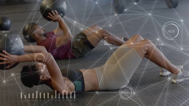 Coach cue starting, woman doing medball sit-ups supine to upright for core work while HUD tracking