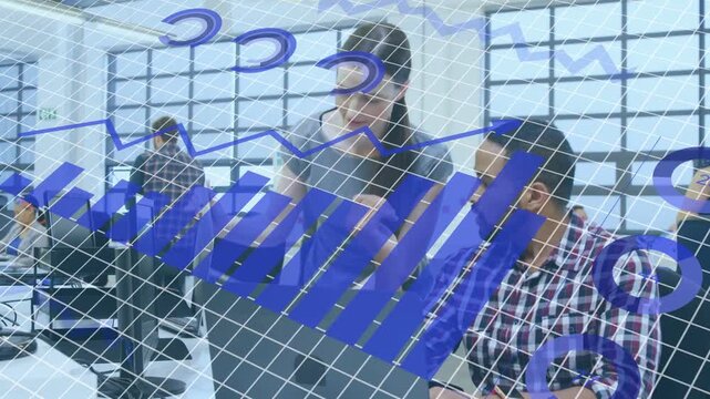 Standing woman presenting doc for review, leaning over seated man, blue charts sweeping tech laptop