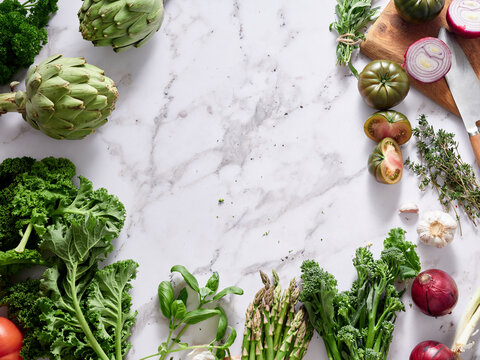 Fresh vegetables on marble countertop for healthy meal prep