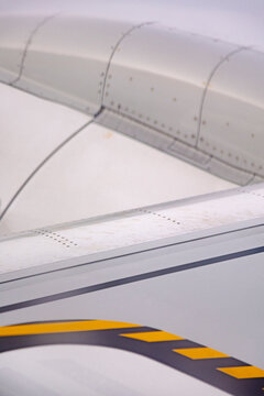 Close-up of airplane wing surface with rivets and panels
