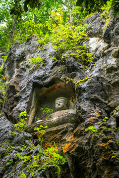 the stone statue avalokitesvara made in Yuan Dynasty from Peak Flown From Afar Fei Lai Fen, Ling Jiu Feng , stands next to Lingyin Temple Hangzhou China