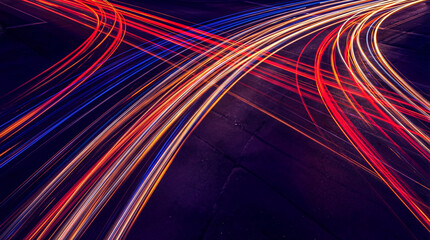 Abstract long exposure photograph showcasing vibrant red and blue light trails converging on a dark asphalt surface. © Jacqueline