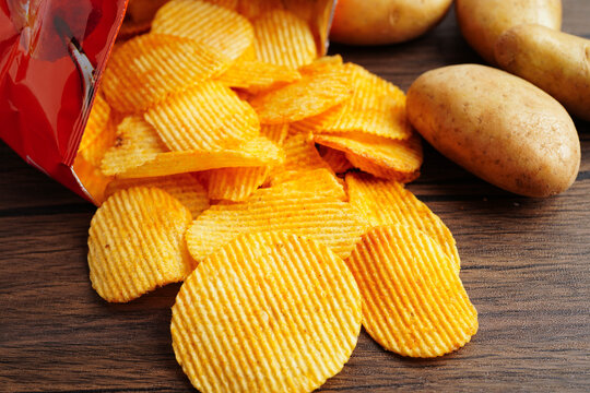 Potato chips in open bag, delicious BBQ seasoning spicy for crips, thin slice deep fried snack fast food.