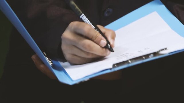 Doctor hands writing on paper document. 