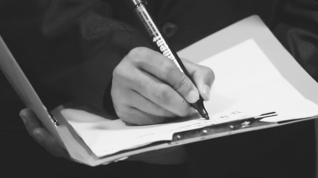 Doctor hands writing on paper document. 