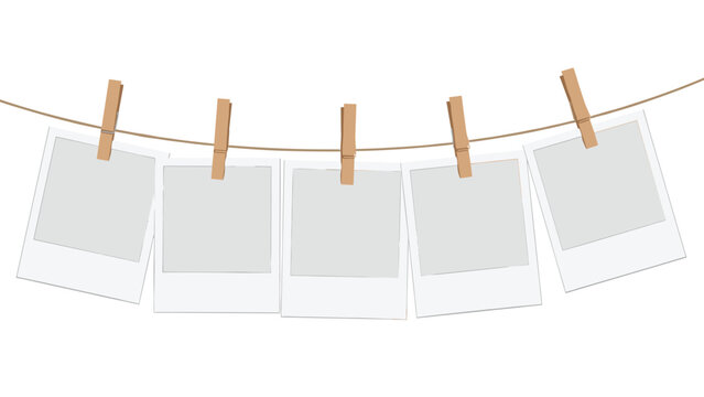Empty polaroid style instant photo frames hanging from a clothesline with wooden pins against a white background.