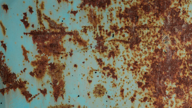 Rusty metal texture with peeling turquoise paint and heavy corrosion
