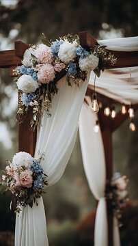 Romantic outdoor wedding arch with pastel flowers and flowing white fabric