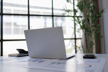 Fototapeta premium Workstation with laptop, documents, and smartphone on a desk