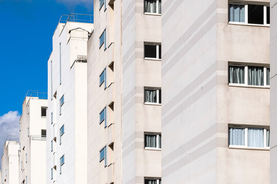 Daylight reveals Paris France residential highrise apartment facade with windows and skyline showing modern urban housing exterior and clean lines