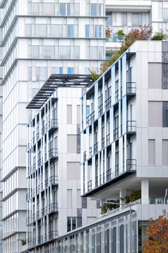 Contemporary urban architecture shows modern residential apartment facade with balconies and windows in Paris France clean exterior elevation view