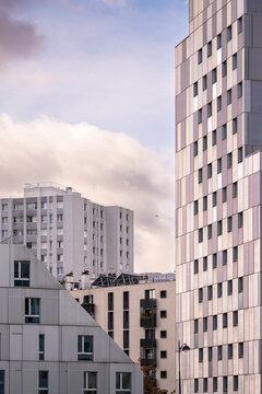 Urban skyline with clouds frames Paris France modern residential highrise apartment facade showing contemporary housing tower exterior and daylight mood