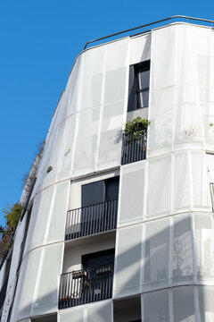 Curved modern residential apartment facade in Paris France with windows and daylight presents contemporary architecture and clean exterior housing view