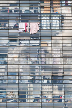 Modern Paris France residential apartment facade uses glass windows grid and reflections creating an urban architecture pattern across the exterior