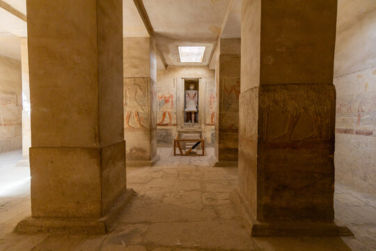 Ancient Egyptian Tomb Interior with Columns and Statue at Saqqara