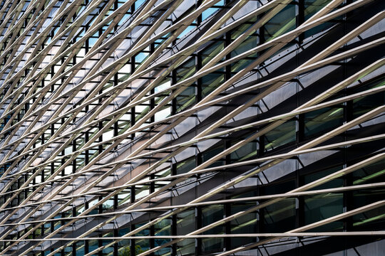 Modern architecture facade with diagonal lines and geometric grid pattern creating abstract texture in a dynamic contemporary detail