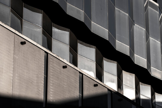 Monochrome modern facade where abstract architecture pattern and geometric lines create shadow texture in a refined graphic composition