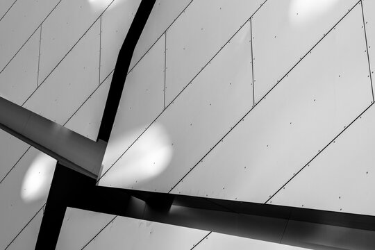 Minimal white facade in modern architecture where abstract geometric lines and pattern define structure in a clean and balanced visual study