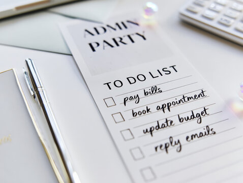 Admin Party To Do List with Pen and Calculator on White Desk for Productivity Planning