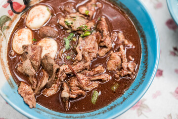 Thai stewed beef, meatball and pork liver in blood soup namtok soup with rice vermicelli noodles. © Dontree