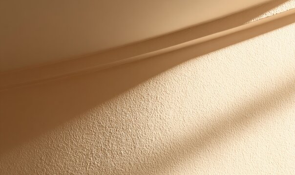 Textured wall bathed in soft, warm light casting gentle shadows