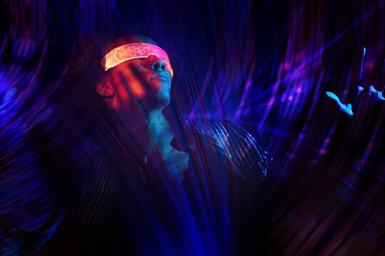 Person exploring neon cyberspace wearing virtual glasses