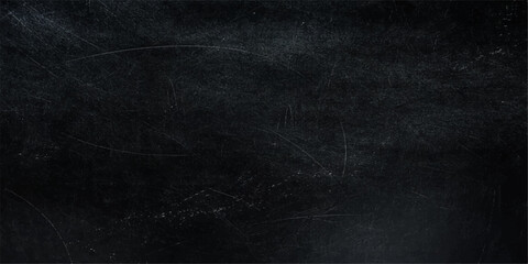 A textured black chalkboard displays various scratches and marks, offering a tactile representation of age and use. © Queality Full