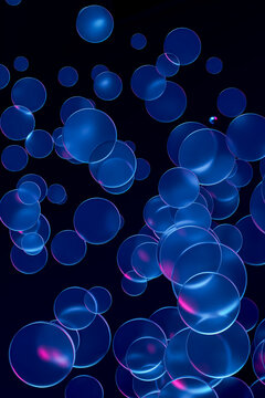 Floating blue glass circles with neon reflection on dark background