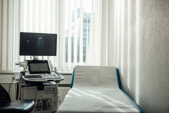 Empty hospital examination room with modern ultrasound equipment