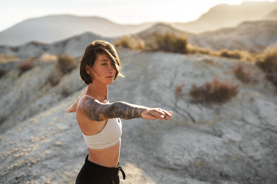 Yogini practicing balance outdoors in the desert