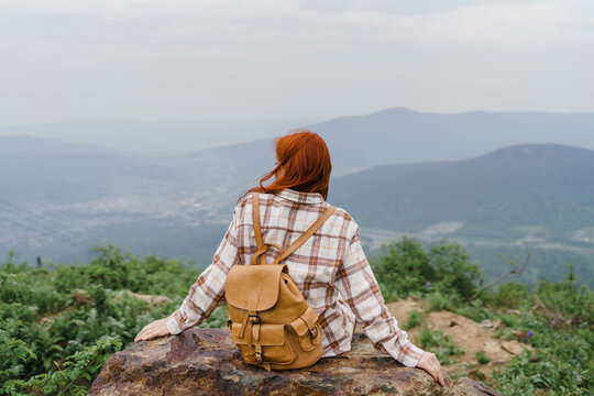 Tourist sitting on rock at Mountain Zelenaya Sheregesh
