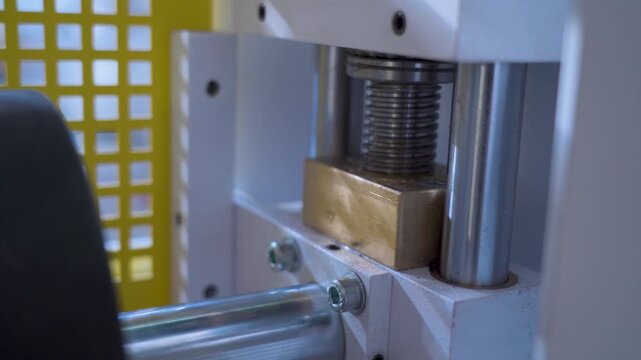 Industrial lead screw mechanism with brass nut and steel shafts close-up